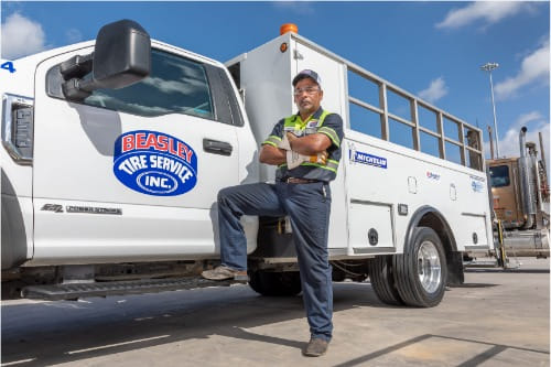 Beasley Tire Service employee posing with truck