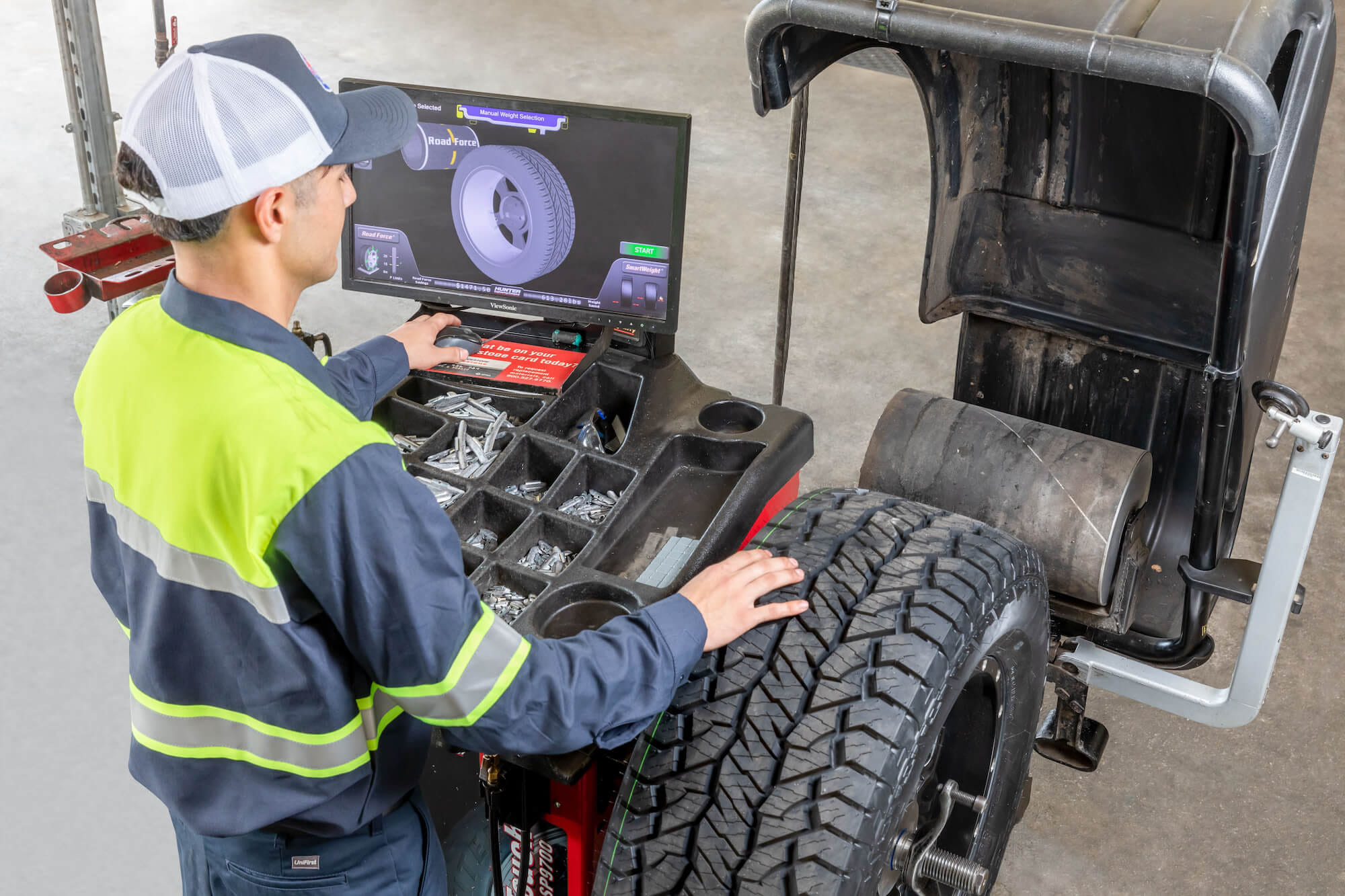 Mechanic looking at tire on computer
