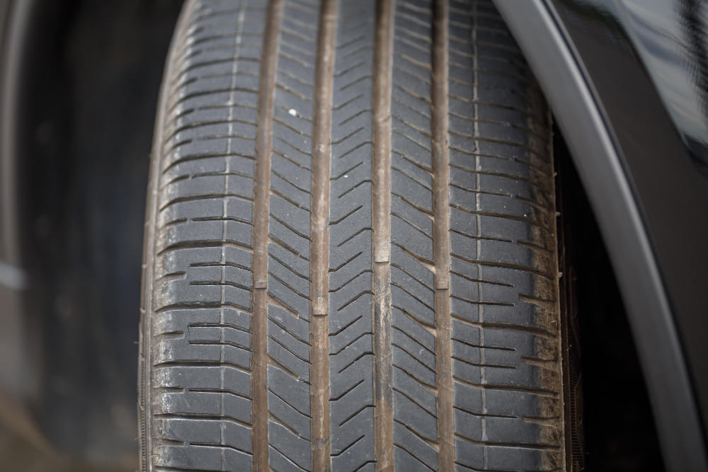 Expert Mechanic looking over tire for vehicle