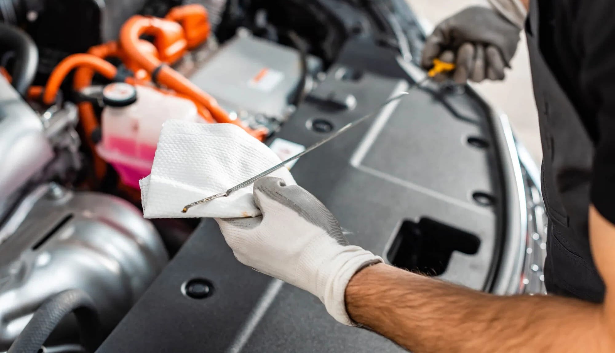 mechanic checking oil in truck