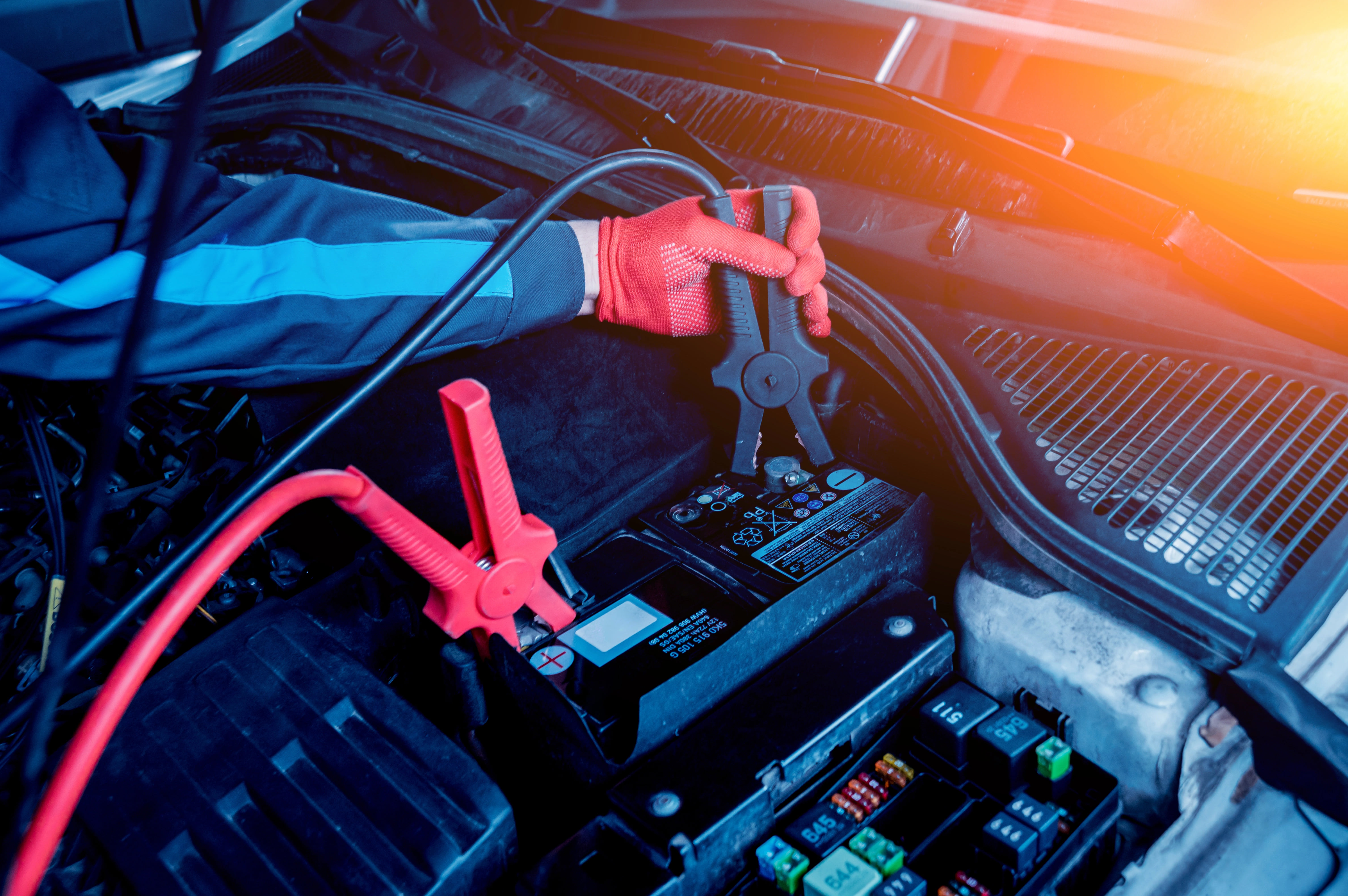 Technician inspecting a commercial truck engine battery