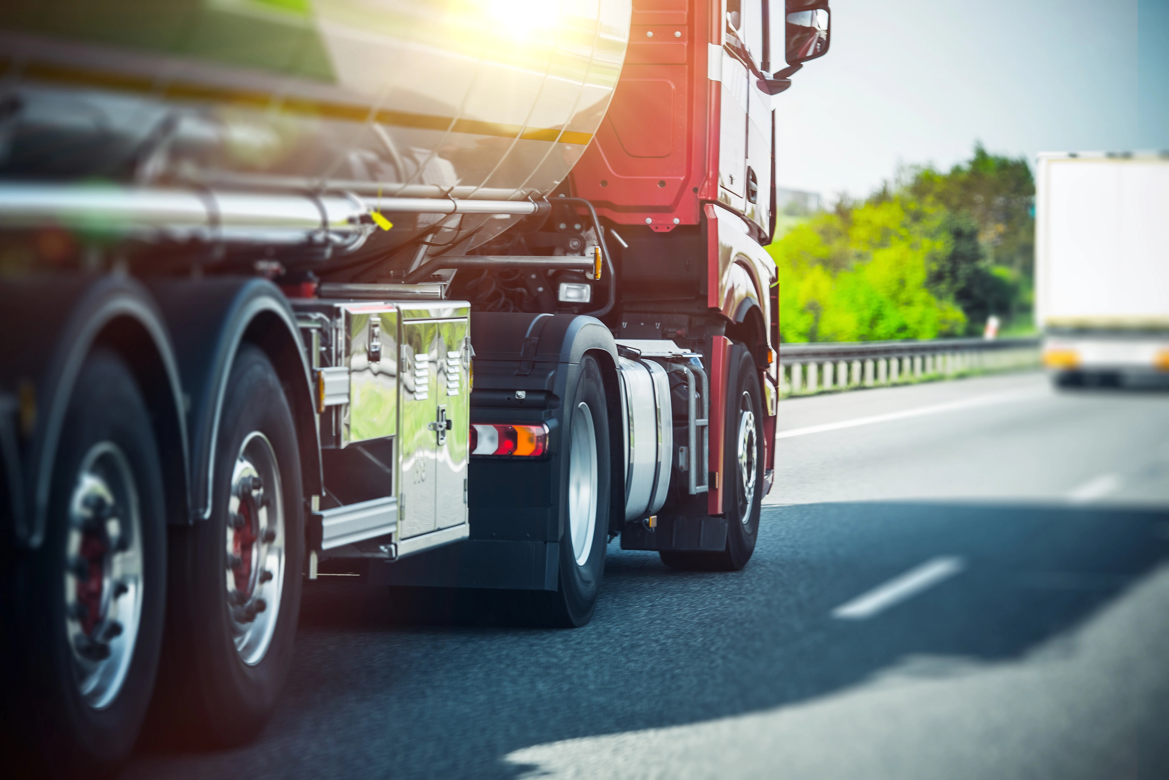 A commercial 18-wheeler parked on asphalt waiting for service