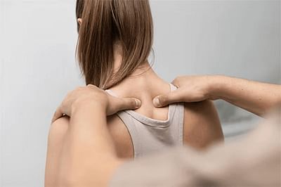 Therapist giving massage to shoulder