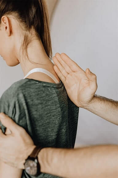 man massaging woman shoulder