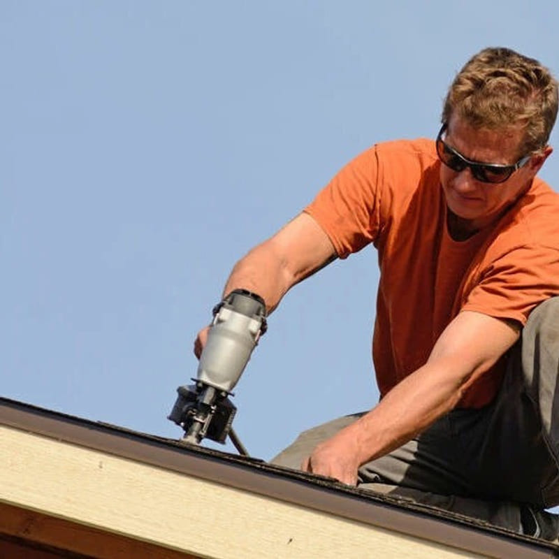 Professional roofer repairing roof structure to stop active water intrusion