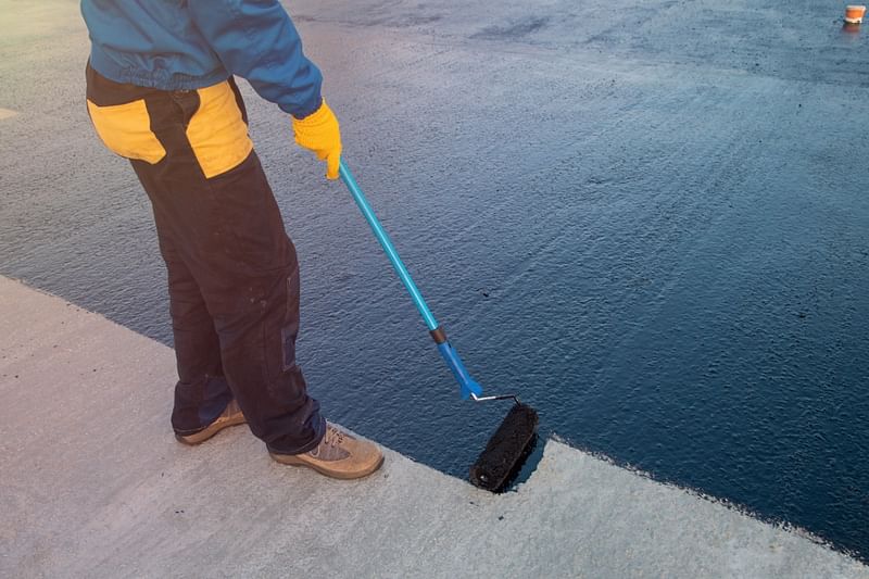 Roofer coating commerical roof