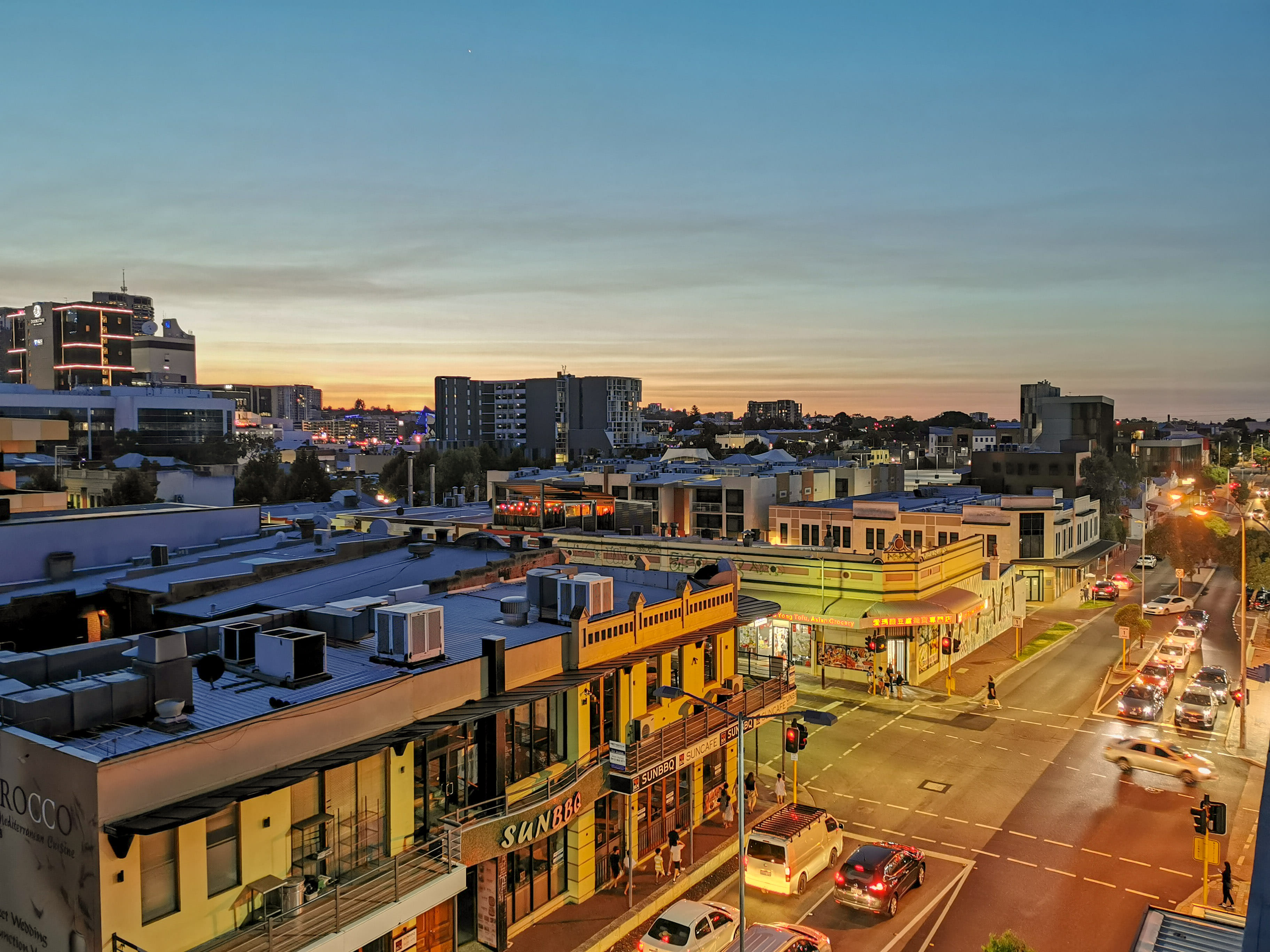 City skyline and commercial district at sunset with buildings and street traffic. City skyline and commercial district at sunset with buildings and street traffic.