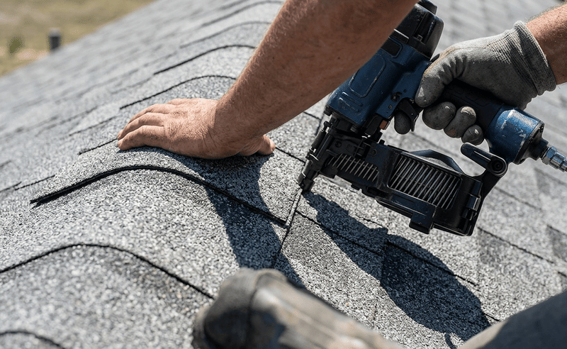 roofer installing asphalt shingles during roof ventilation upgrade roofer installing asphalt shingles during roof ventilation upgrade