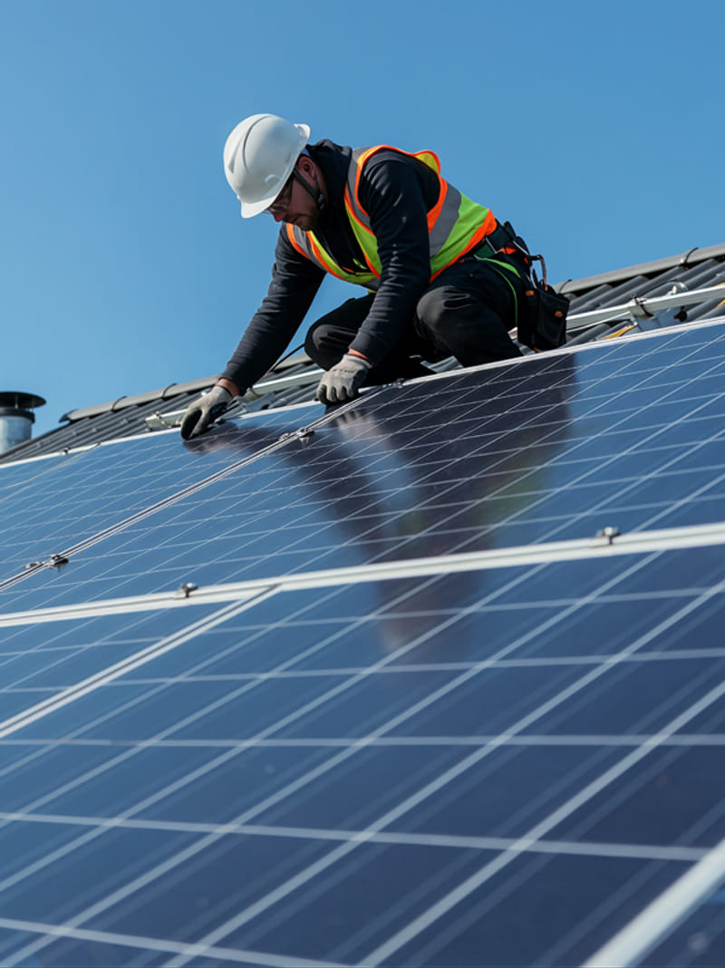 roofing technician installing solar roof panels on residential home roofing technician installing solar roof panels on residential home
