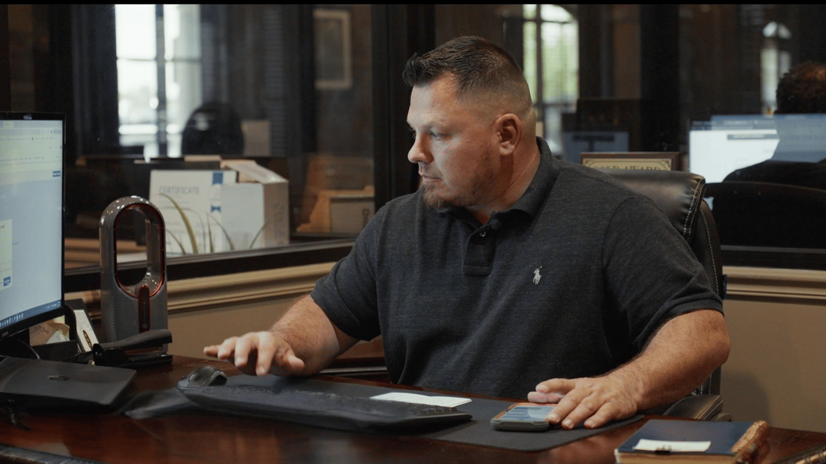 Real estate agent working at a desk in the EXIT Real Estate Consultants office in DeRidder, Louisiana