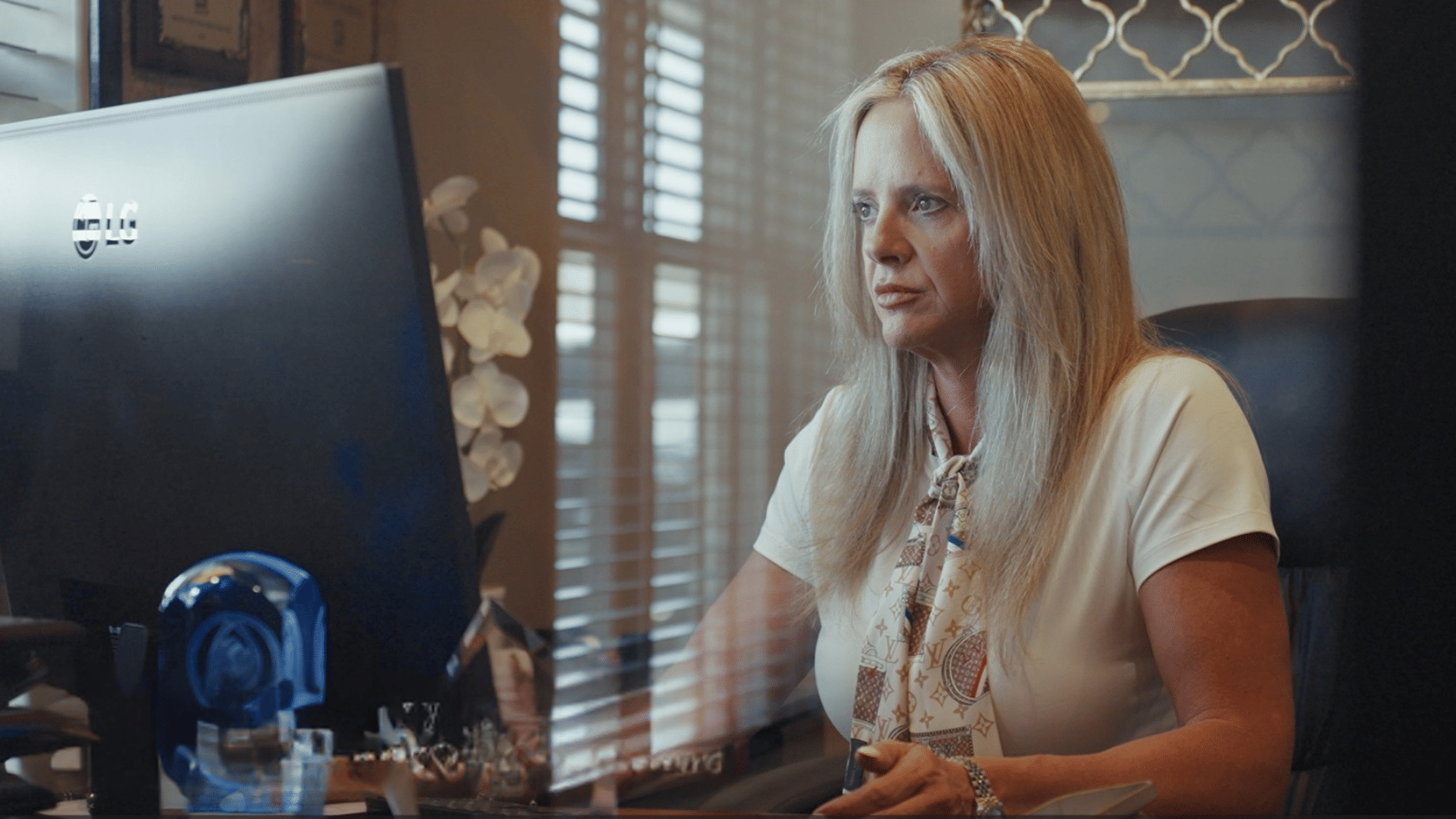 Real estate agent working at a computer inside the EXIT Real Estate Consultants office in DeRidder, Louisiana