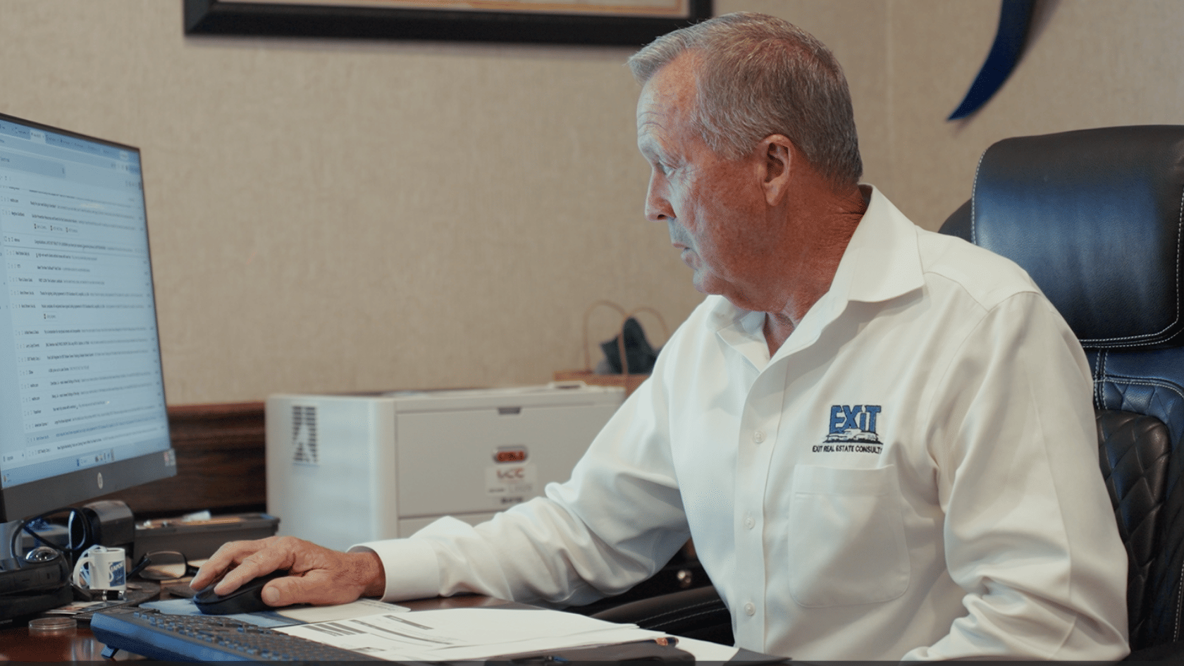 Real estate broker working at a large executive desk inside a private office with wood finishes and professional décor in DeRidder, Louisiana