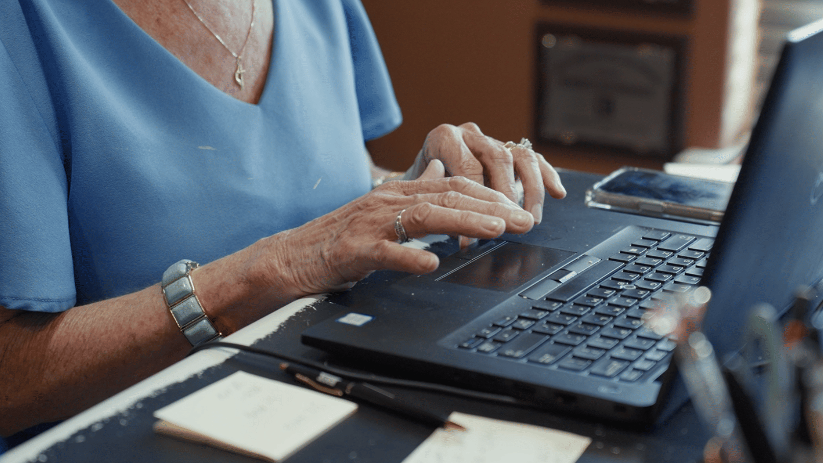 Close-up of a real estate agent using a laptop at the EXIT Real Estate Consultants office in DeRidder, Louisiana