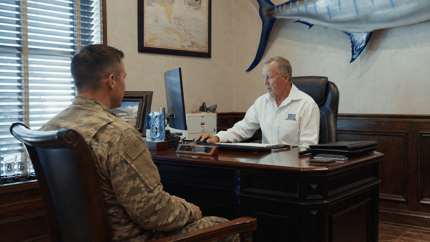 EXIT Real Estate Consultants broker meeting with a U.S. Army service member to discuss military relocation and home buying.