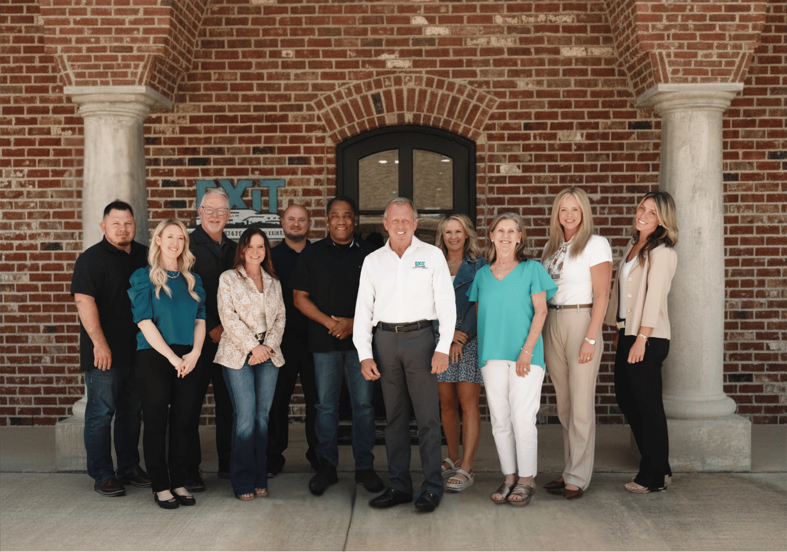 Group photo of the real estate team standing outside the EXIT Real Estate Consultants office in DeRidder, Louisiana