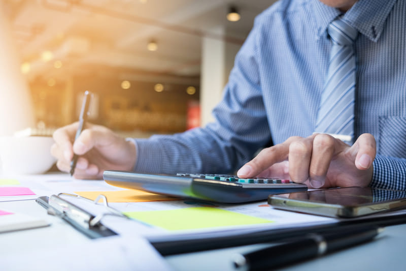 Close-up of calculator and pencil on financial documents during bookkeeping work Close-up of calculator and pencil on financial documents during bookkeeping work