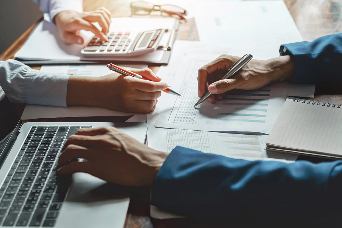 Accountant reviewing financial spreadsheets with a calculator and notes