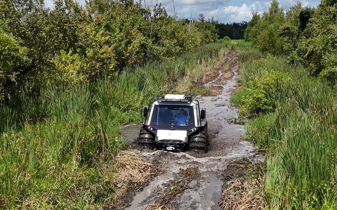 white fat truck sitting in dirt