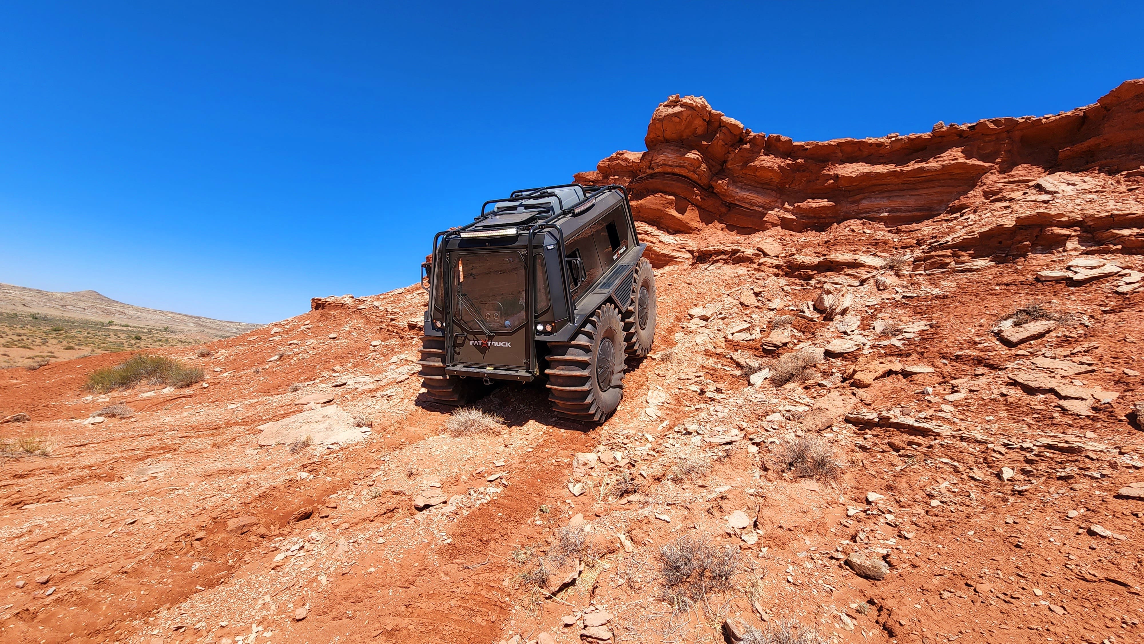 Fat Truck driving down red rocky terrain