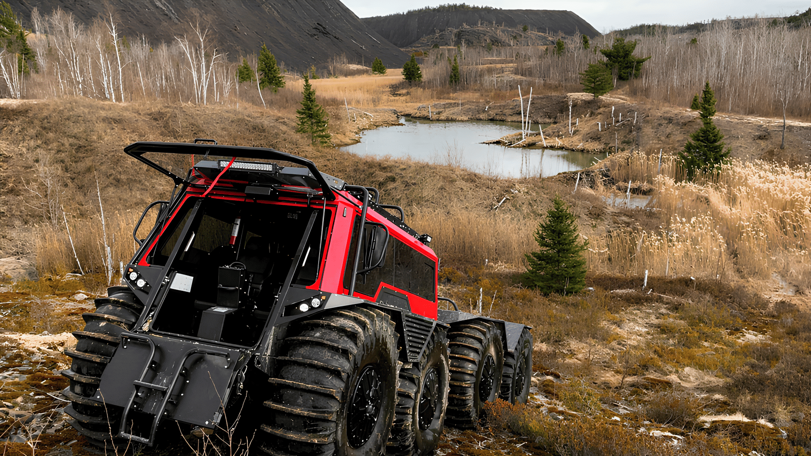 orange red fat truck driving near a pond