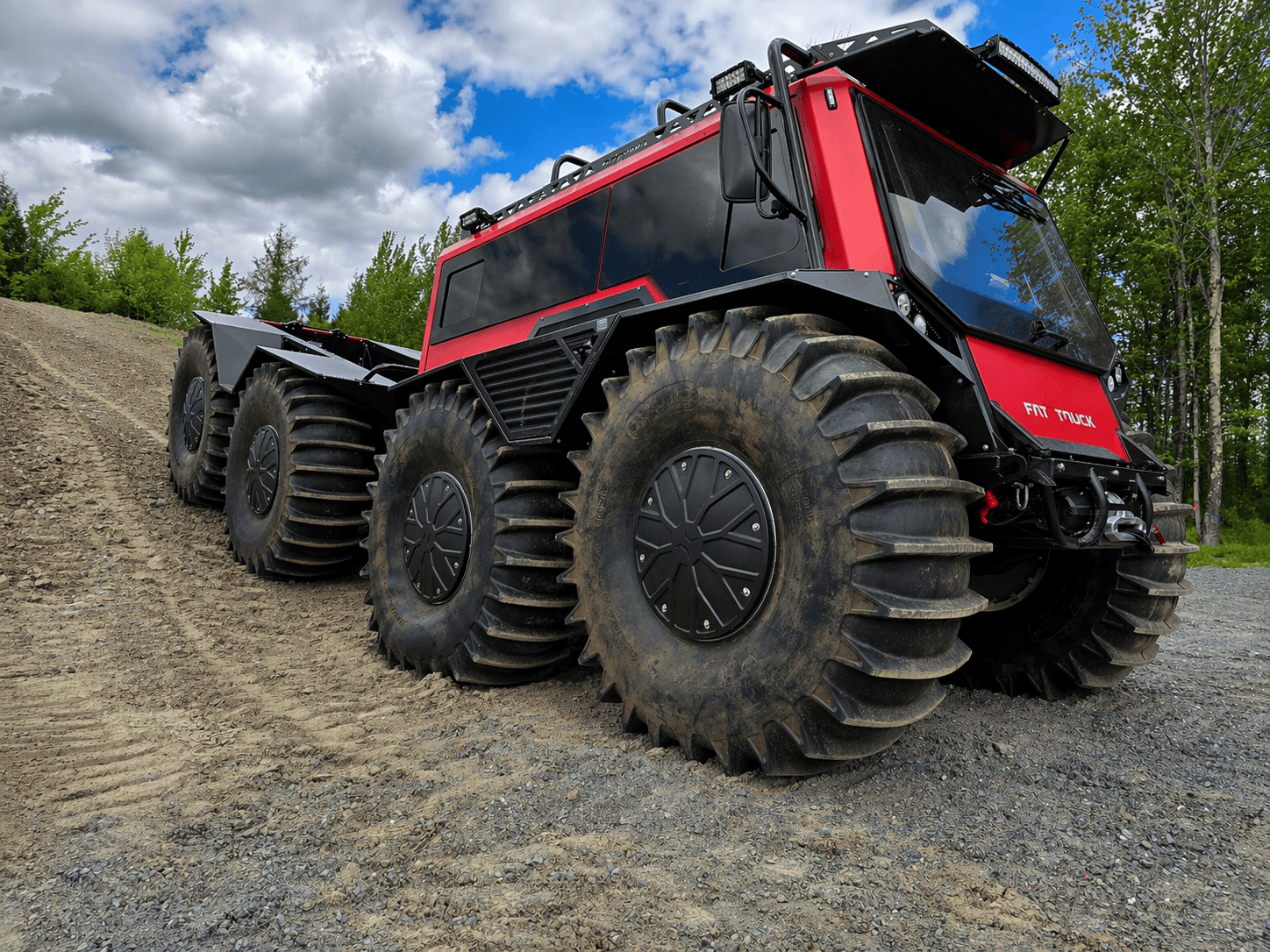Red Fat Truck with trailer moving in dirt terrain for a project