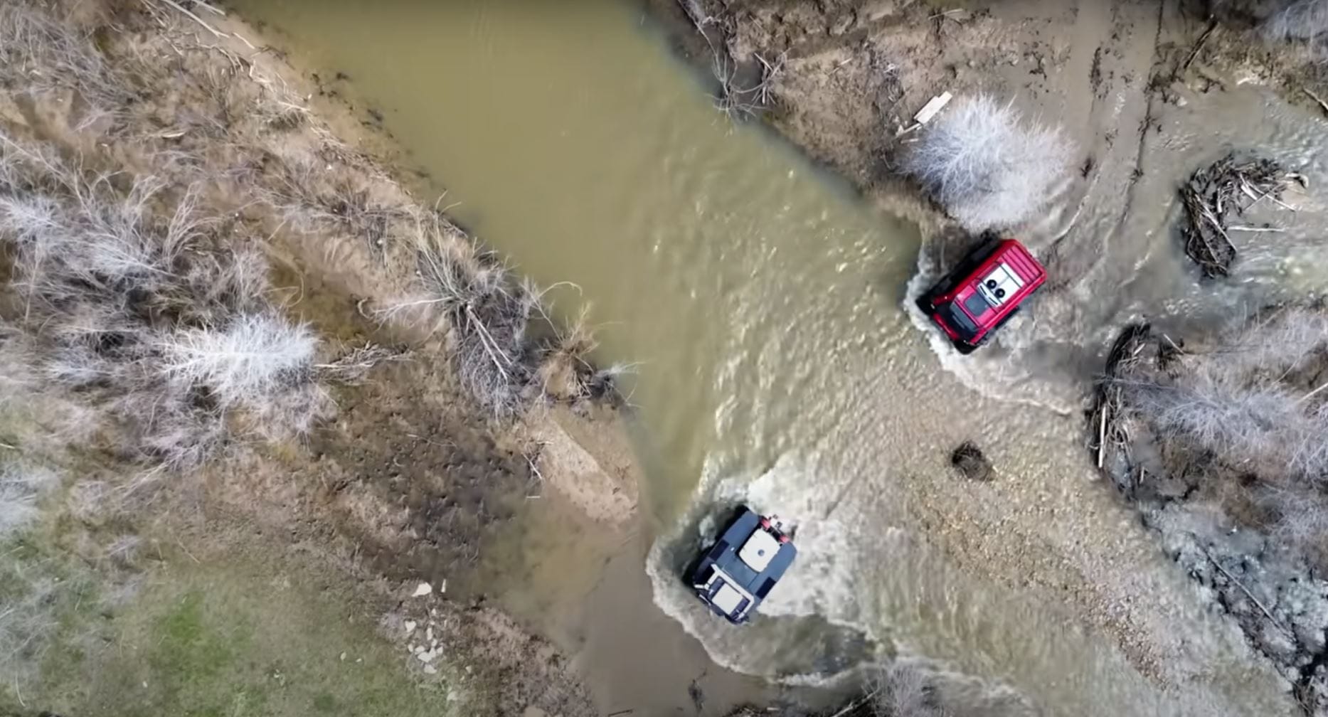 Two Fat Trucks moving through low-level river water across the terrain