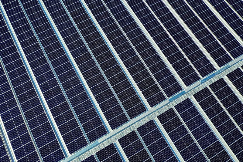 close-up on solar panels laying across rooftop
