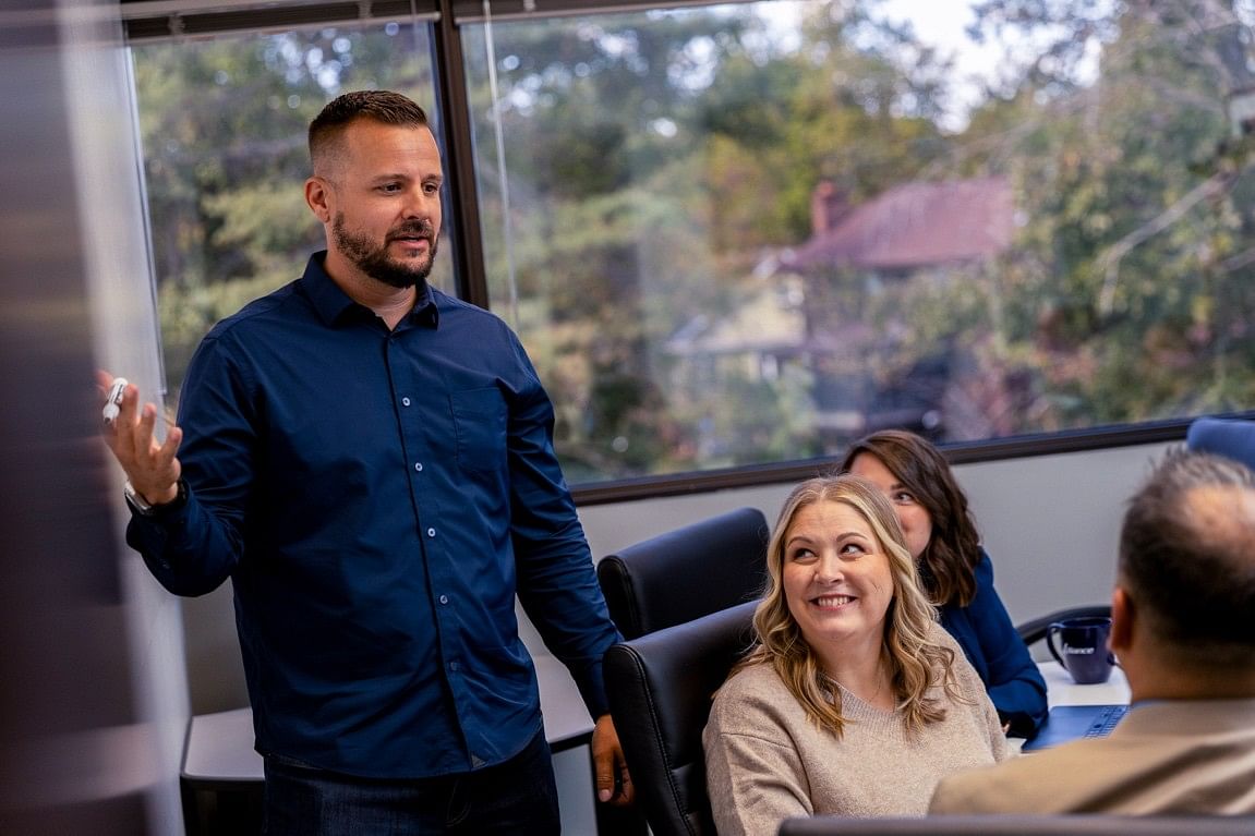 Business leader and team discussing strategy for scalable growth