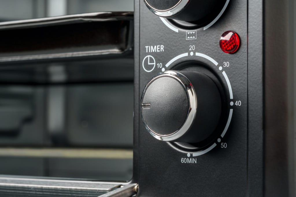 Oven control knob with timer icons and service badges