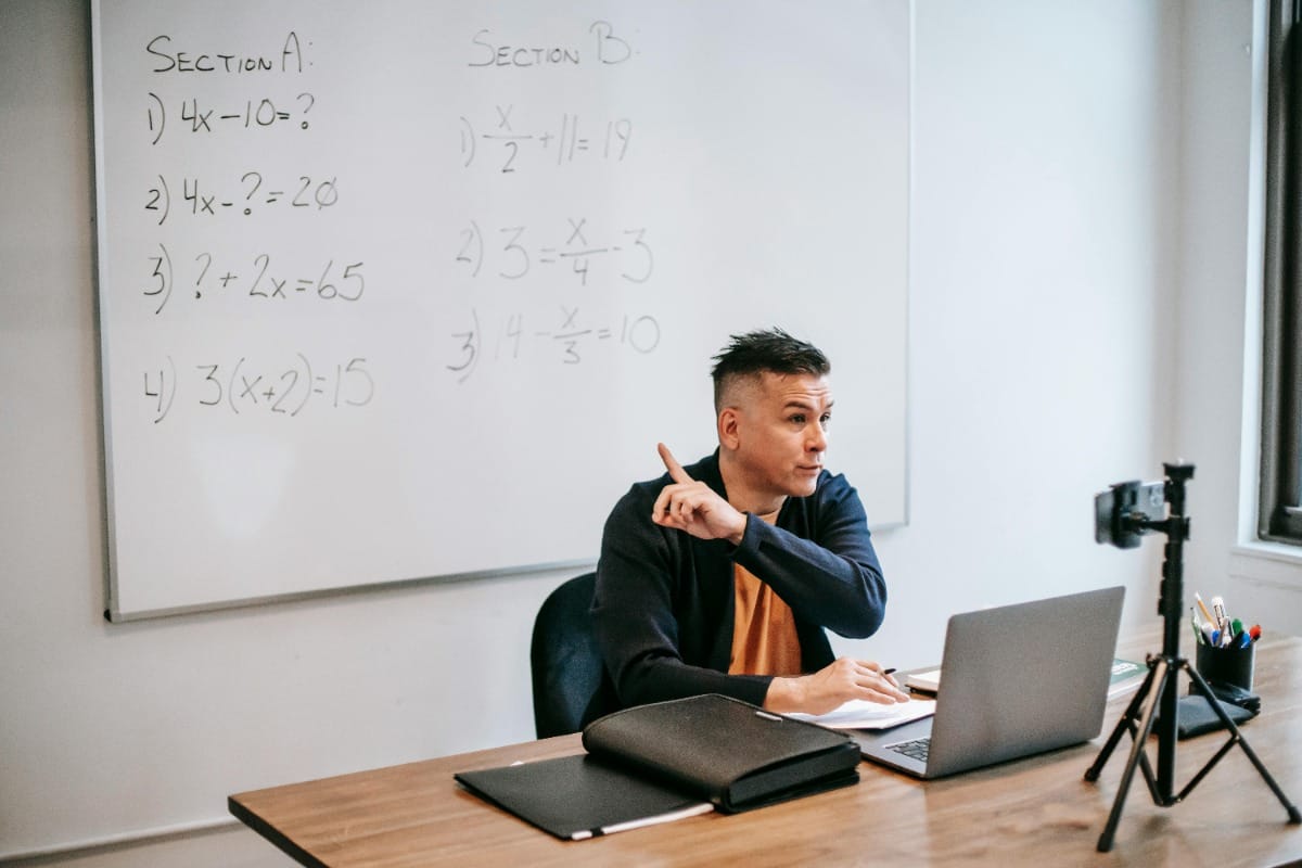 Math Professor teaching as he records on laptop