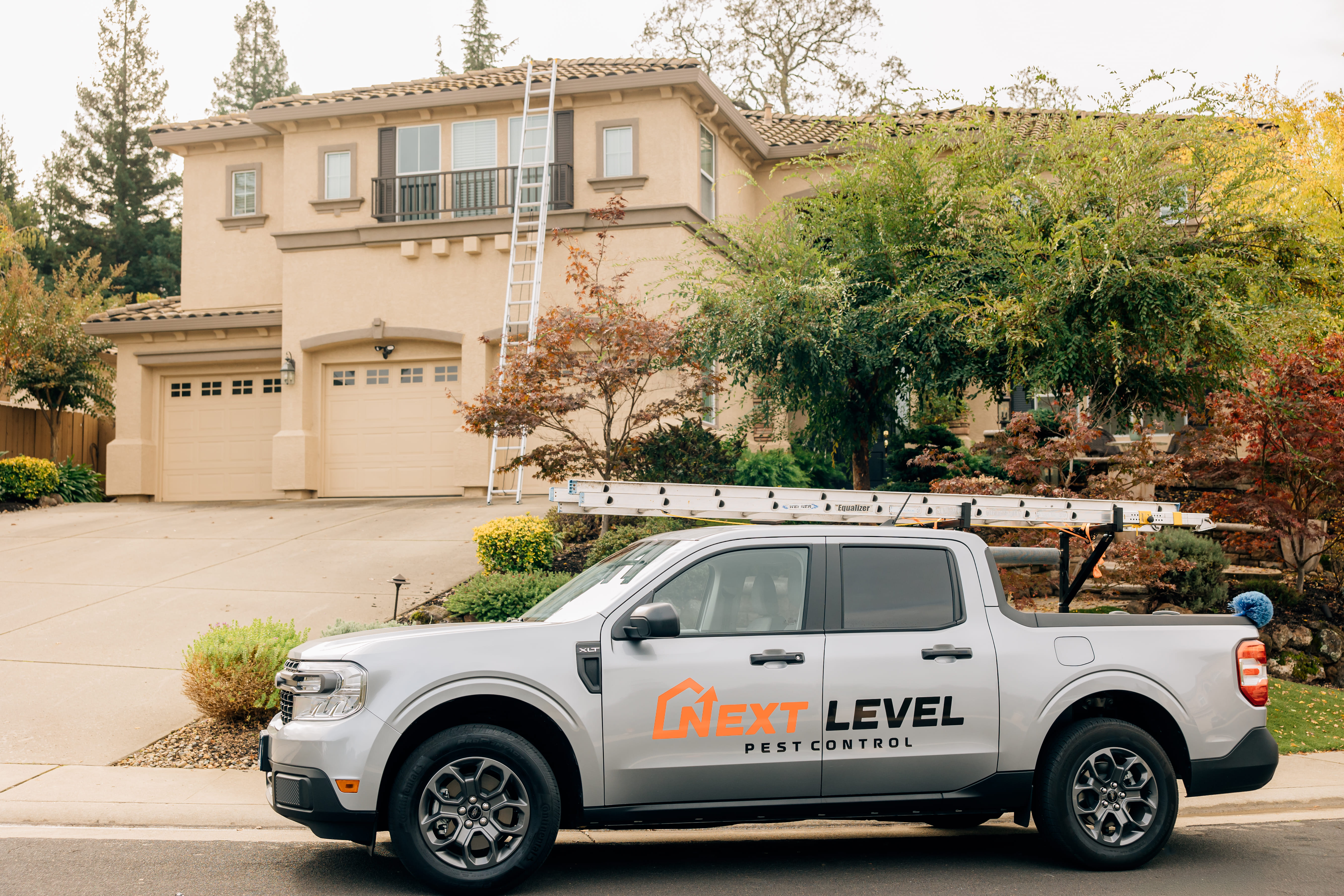 Next Level Pest Control service truck parked at Roseville residence for pest treatment