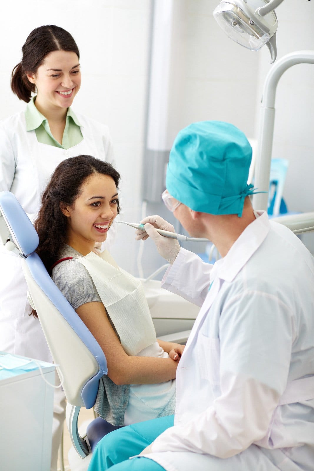 Orthodontist examining a patient during a routine orthodontic visit Orthodontist examining a patient during a routine orthodontic visit