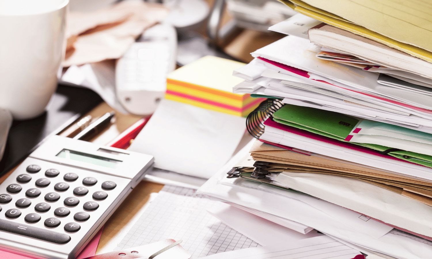 Messy desk of notebooks