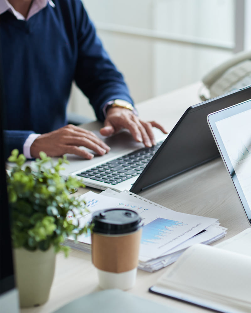 Business advisor analyzing financial documents and entity structure planning materials at desk