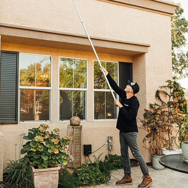 Residential pest control service treating home exterior entry points in Sacramento