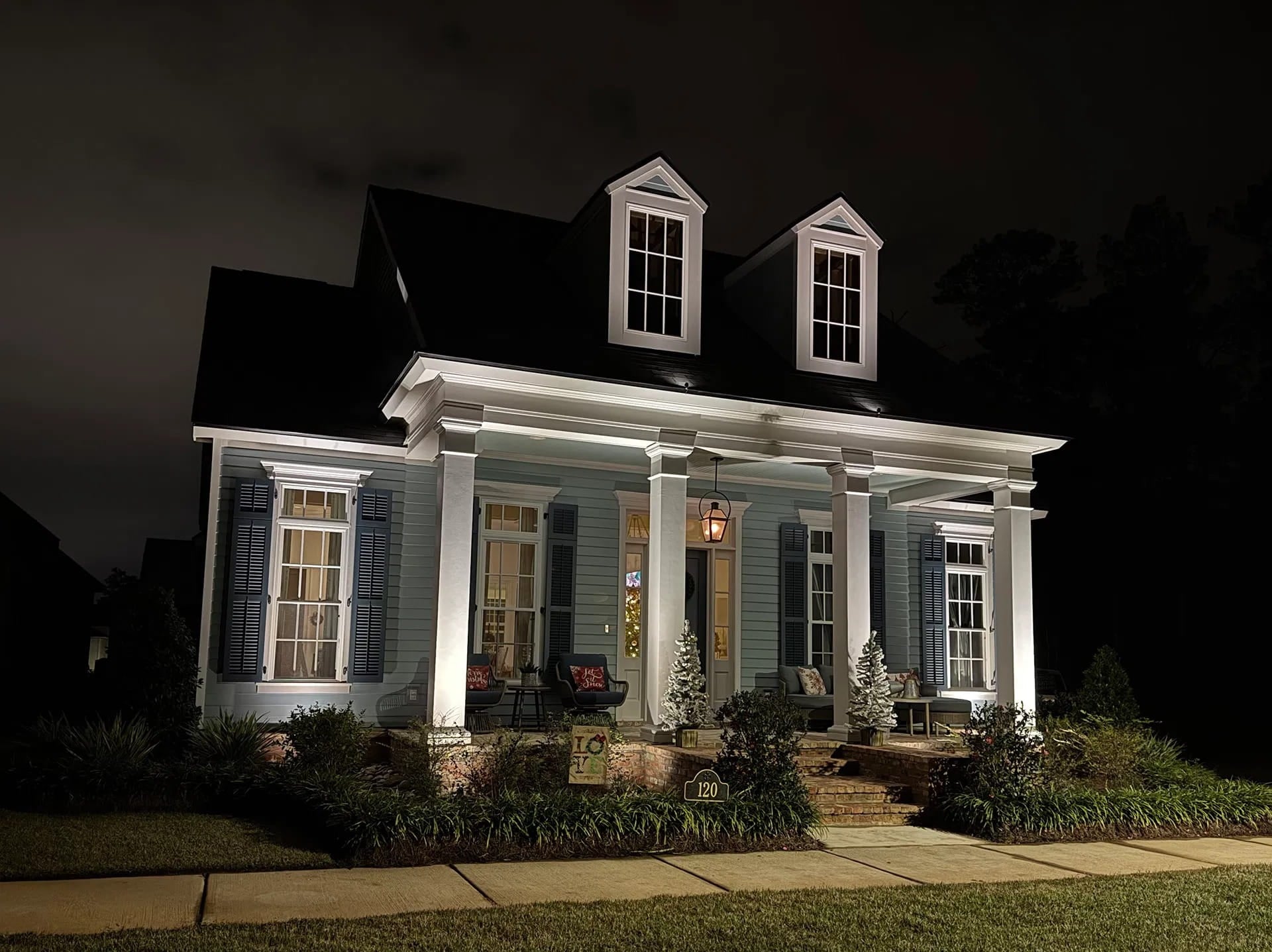 exterior home lighting on blue home in Covington, LA
