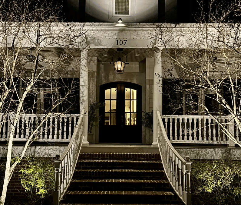 Warm landscape lighting on Louisiana home in New Orleans at twilight