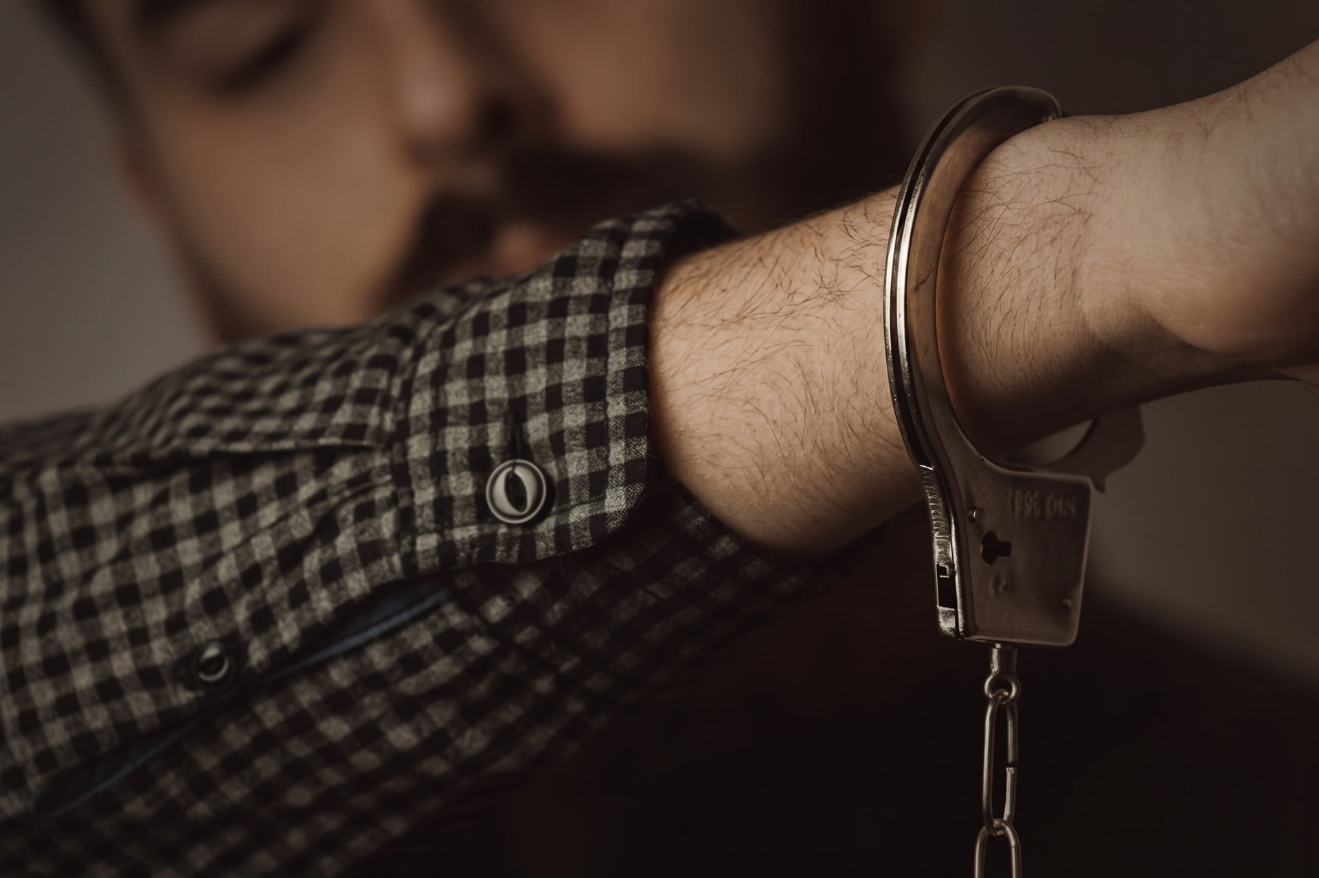 man showing a handcuff on his wrist
