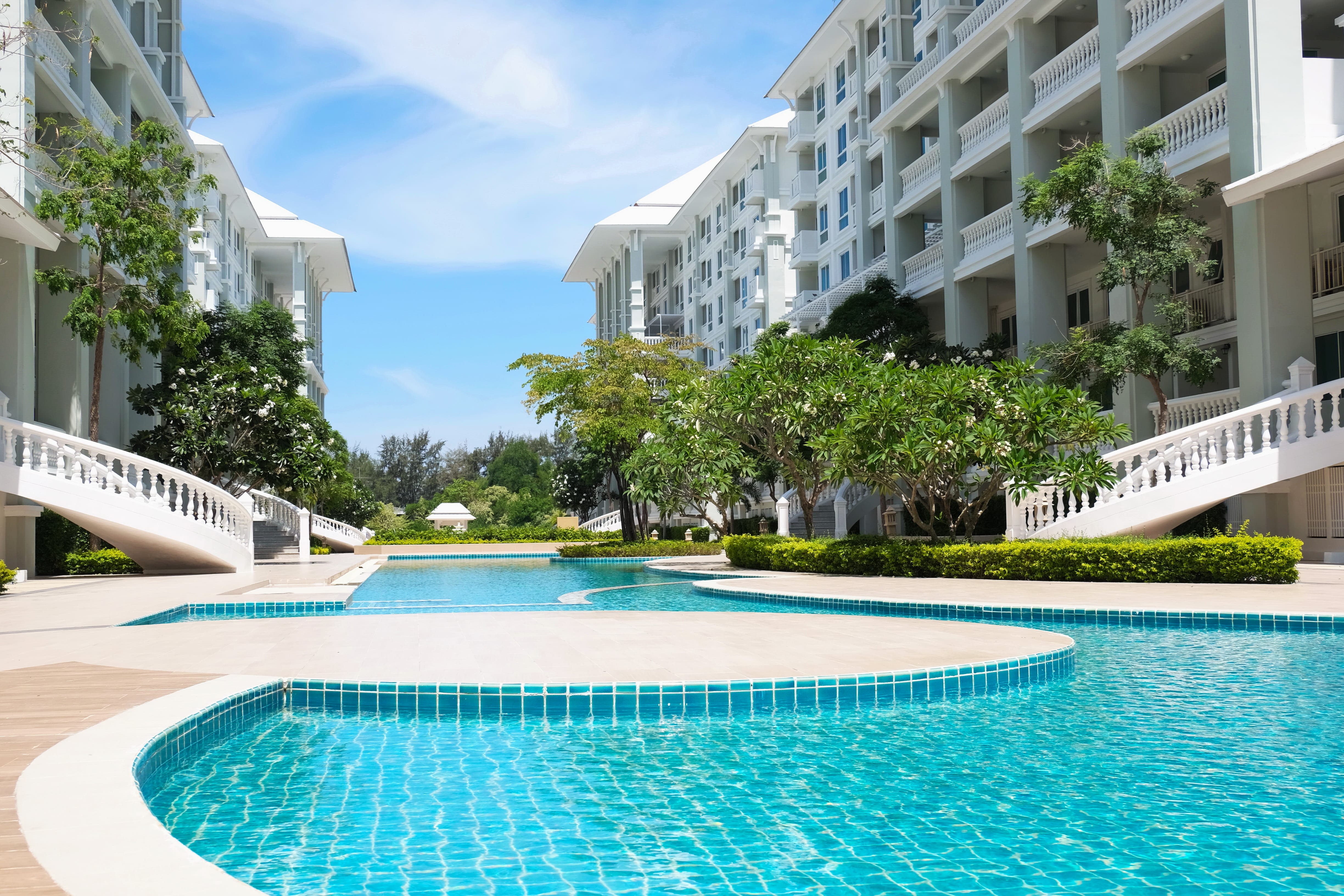 beaitiful blue tile pool outside high-end apartment complex