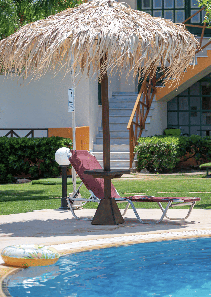grassy umbrella over a deck chair near pool