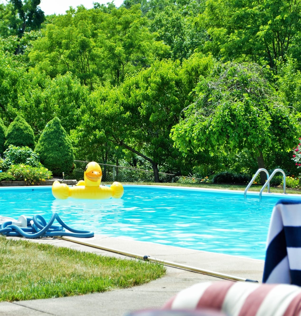 backyard with a clear blue water pool with on sunny day