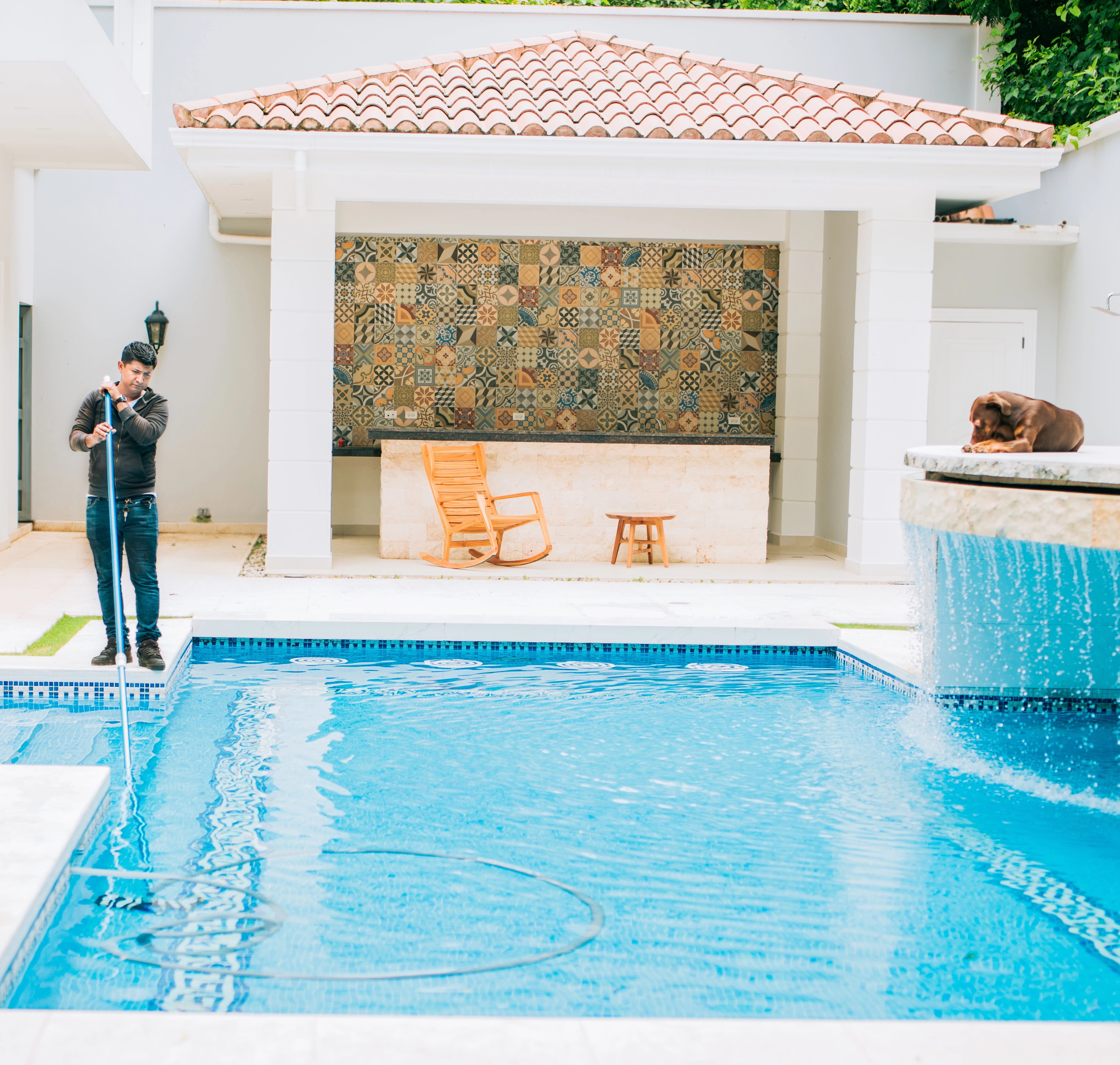 man cleaning pool in Florida using the right equipment