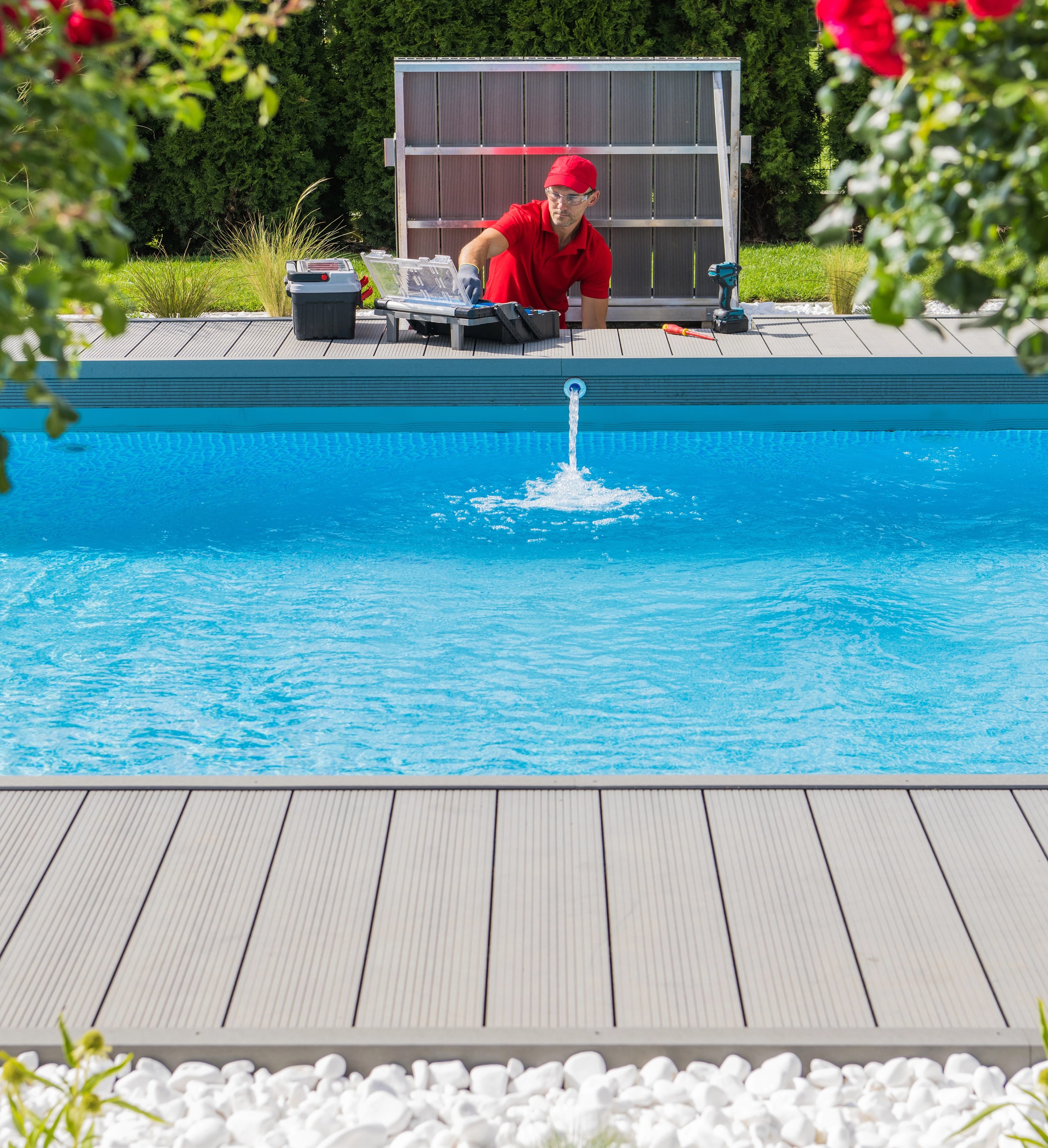 PoolReady worker carrying pool cleaning near pool