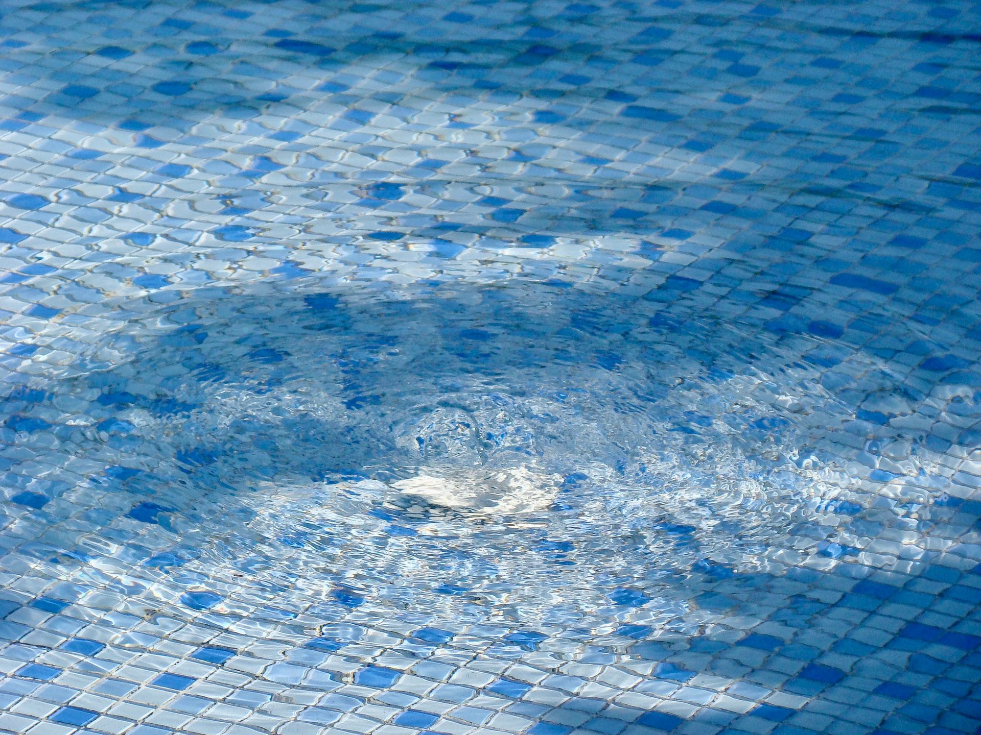 water rippling in pool with light blue and dark blue tile
