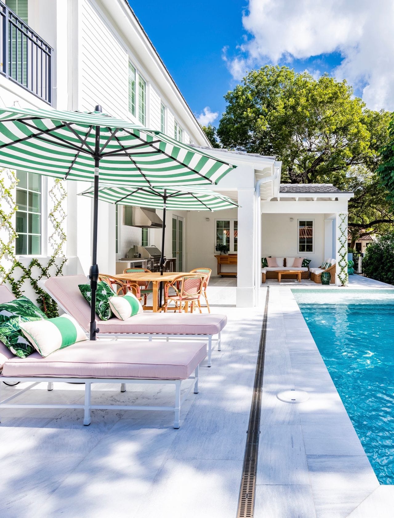blue water in pool surrounded by tropical trees and a spanish tile gazebo