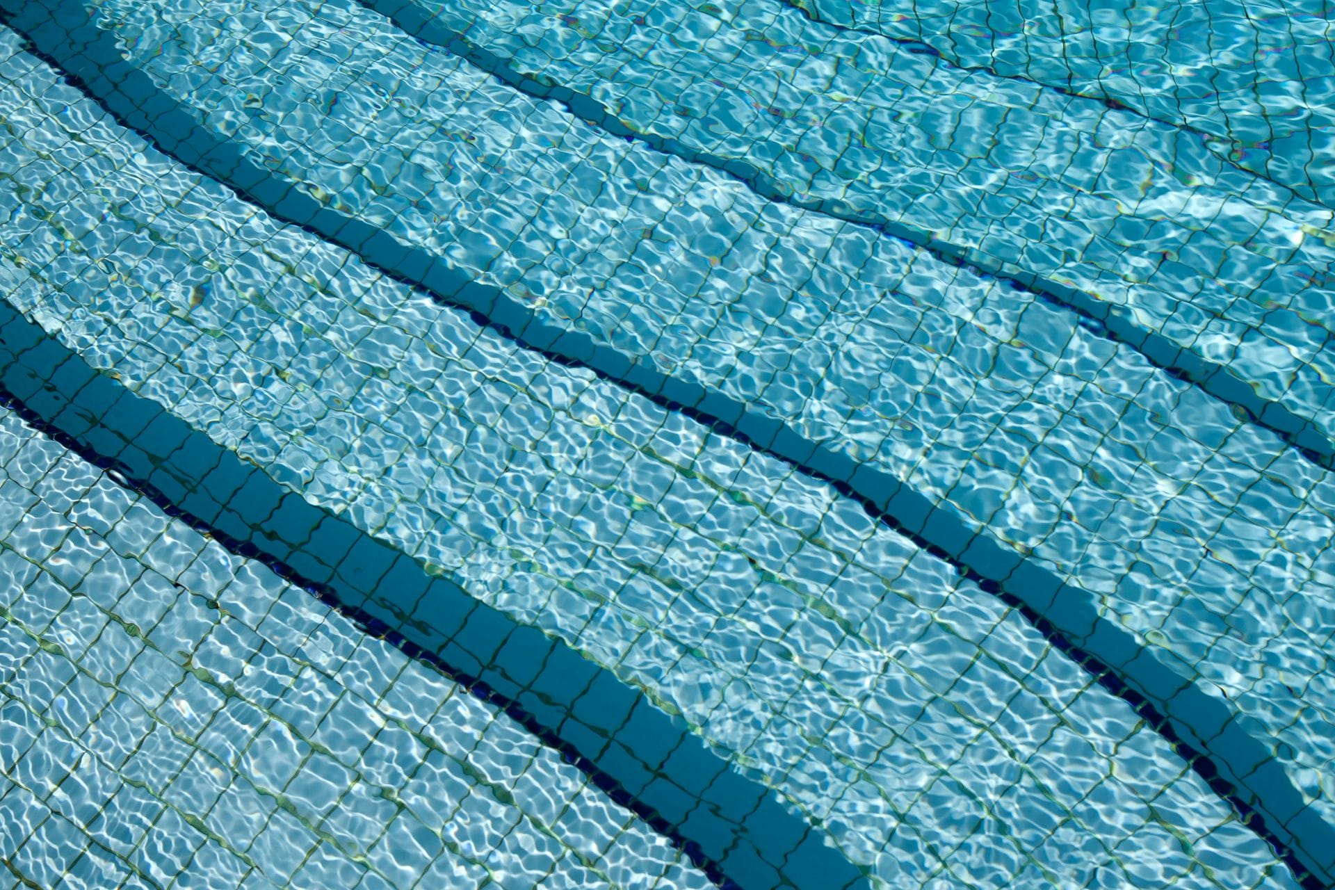 water rippling in pool with light blue and dark blue tile