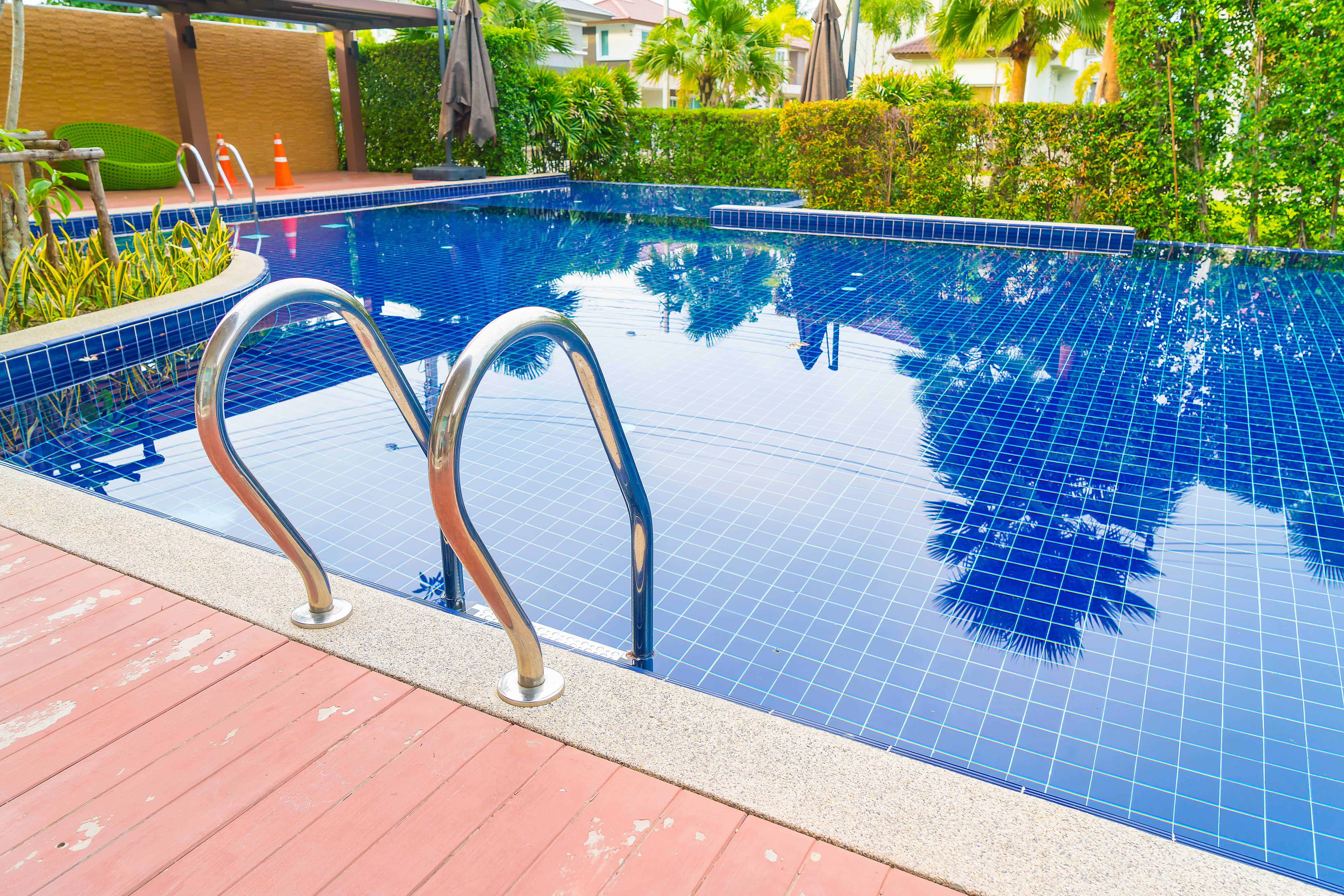 Luxury resort swimming pool with stairs and clear blue water
