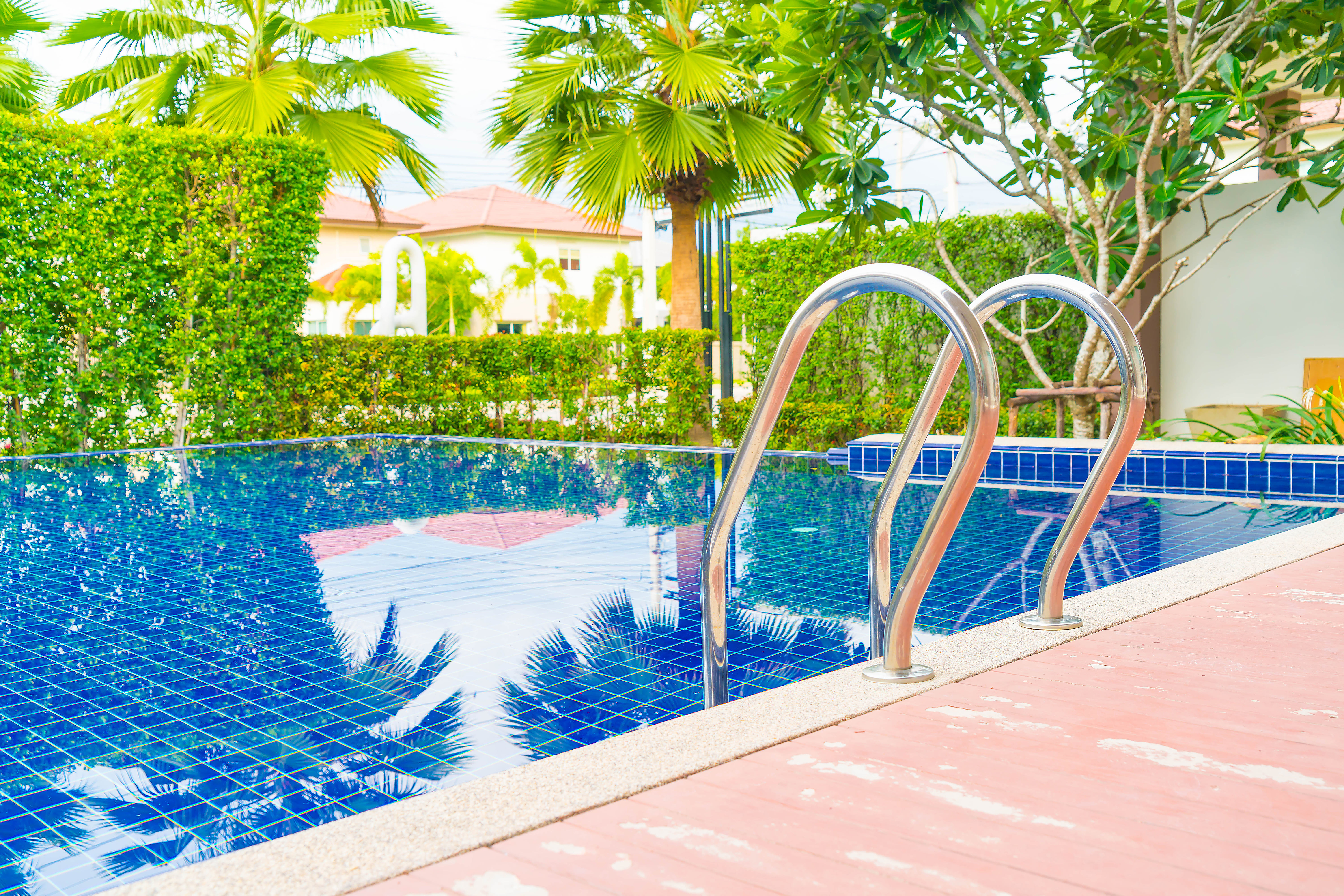 Luxury hotel pool with swimming pool ladder and clear blue water