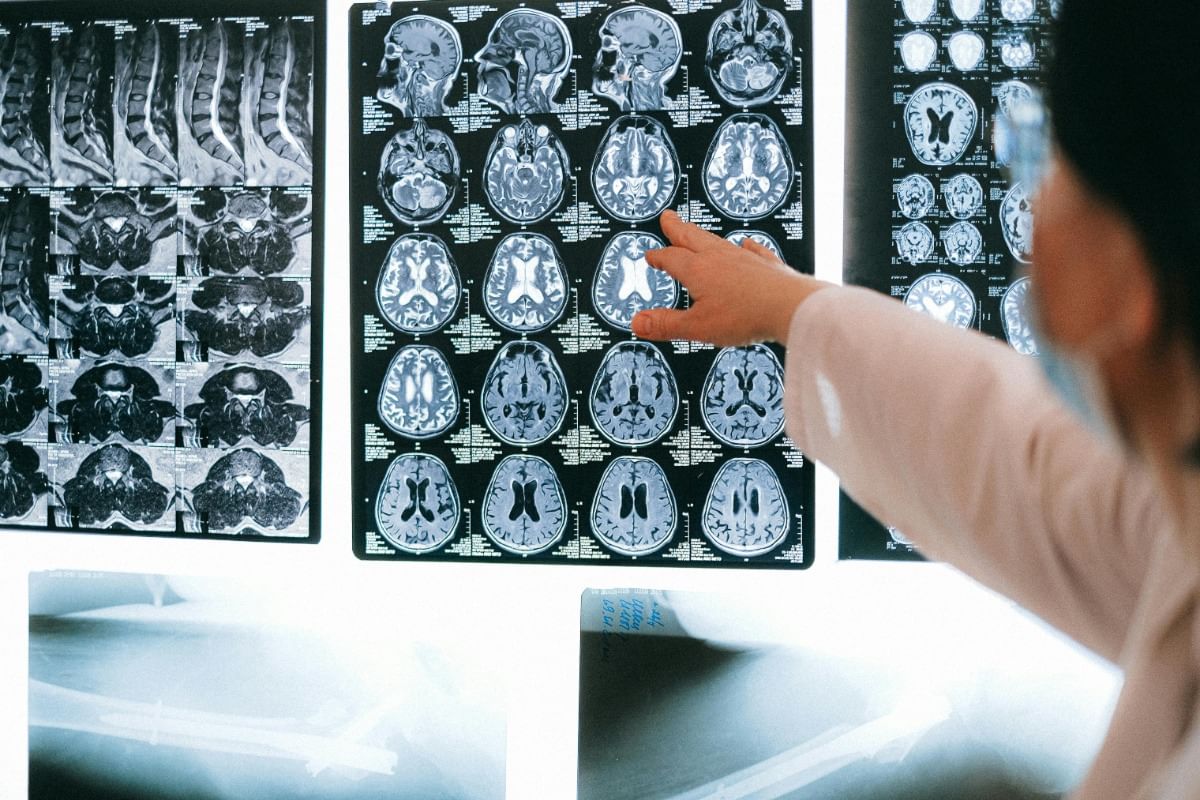 woman looking at her hands with doctor