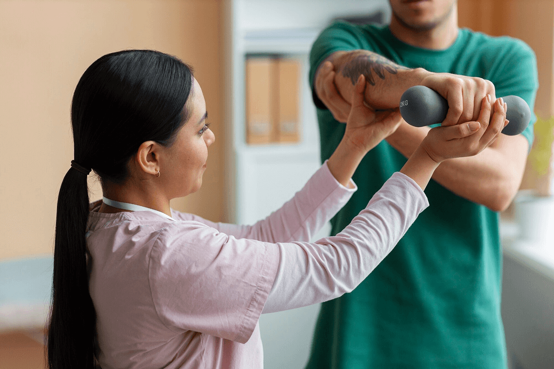A physical therapist helping patient hold up his arm